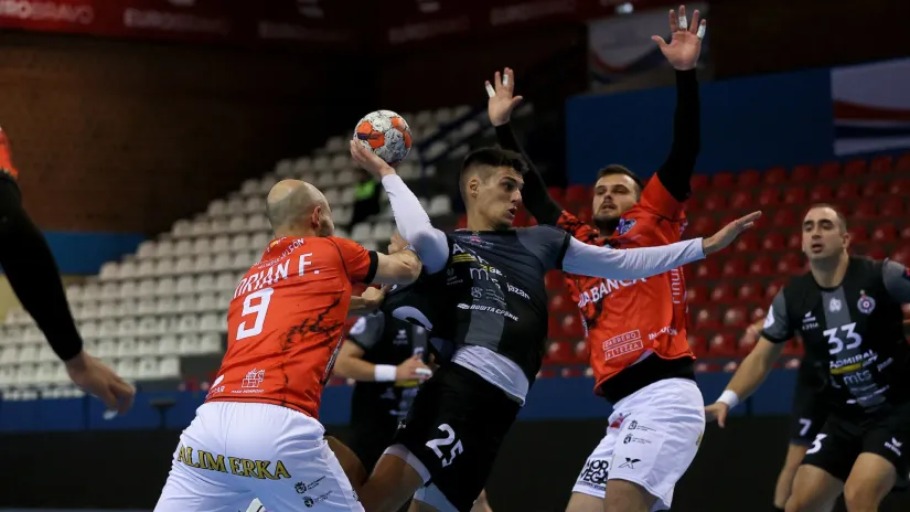 Veljko Popović prolazi pored dvojice rukometaša Ademar Leona (©Starsport)